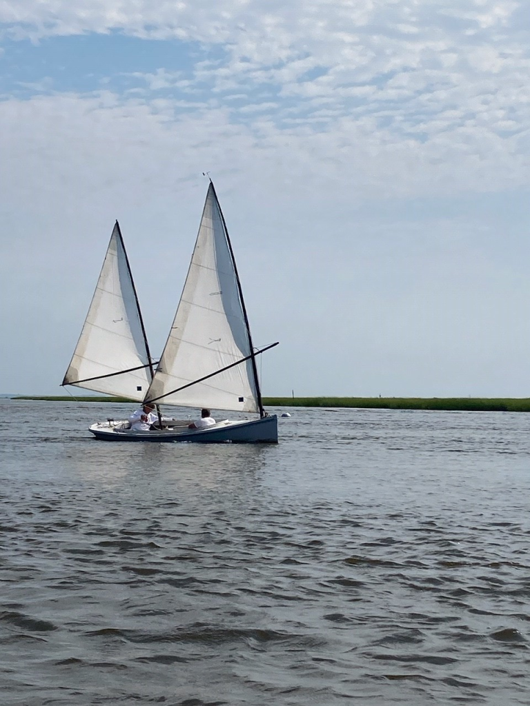 Rich Roach sailing his back yard built New Haven Sharpie Near the mouth of the Connecticut River